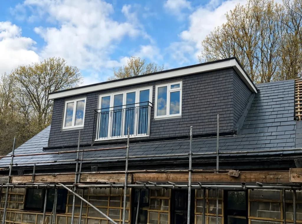 Finished rear dormer loft conversion with slate cladding, uPVC windows and a Juliet balcony
